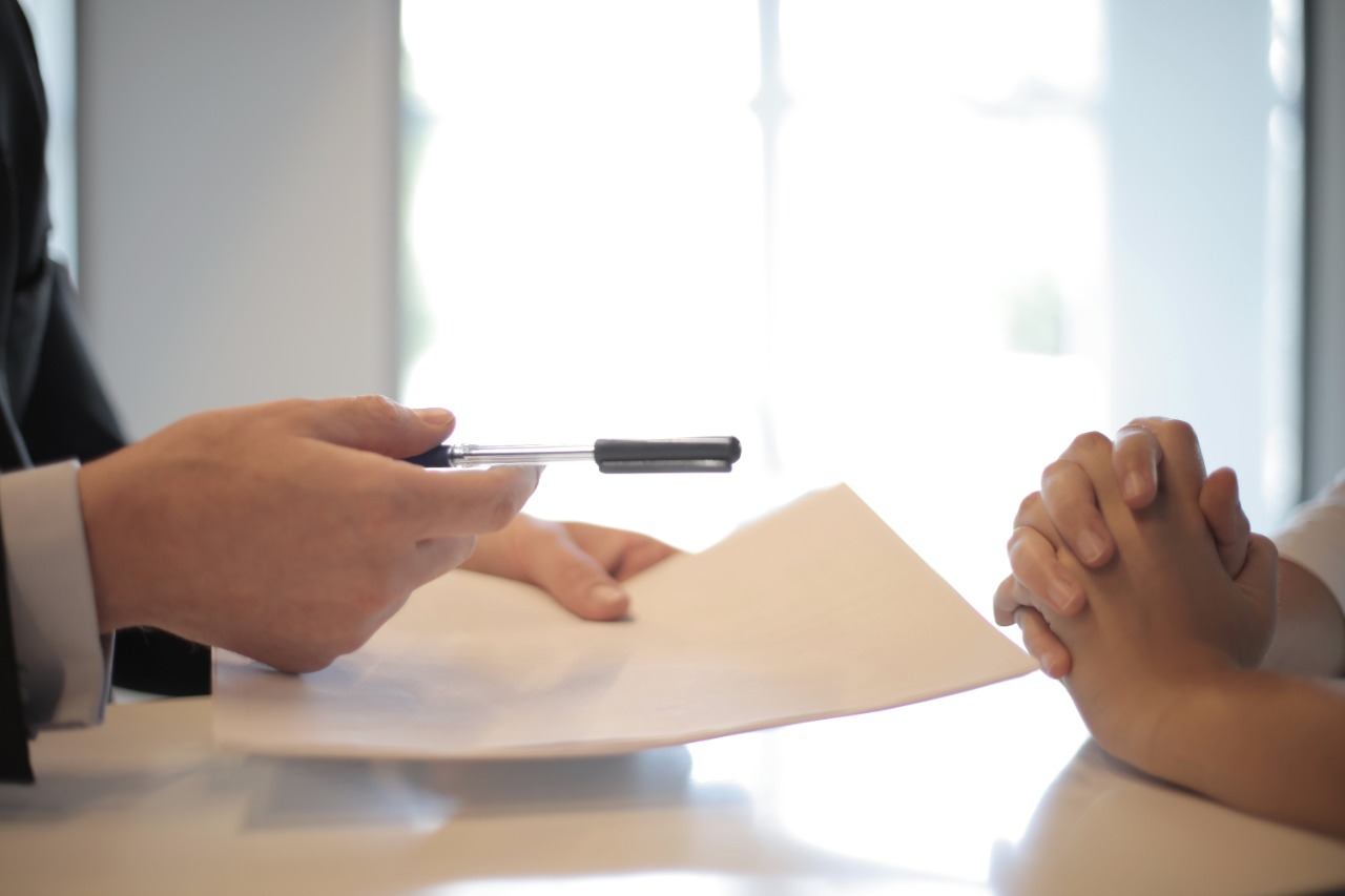 Men Giving Pen and Paper for Franchise Agreement