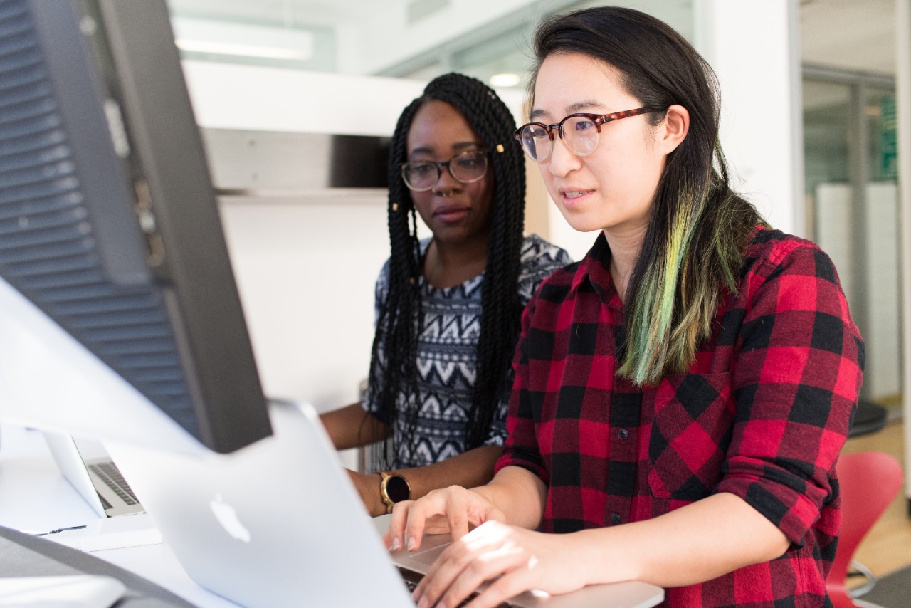 2 Women Working on laptop for Franchise agreement